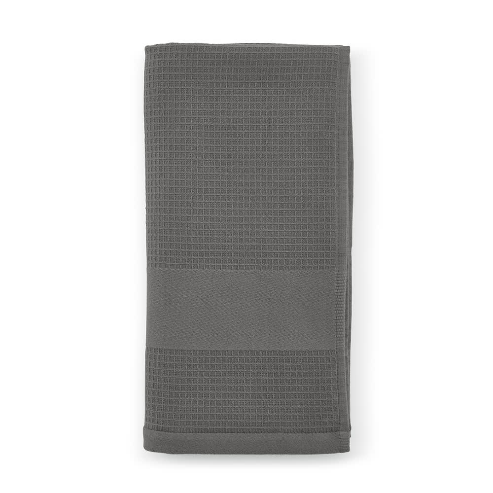 A folded grey towel with a textured pattern, featuring a branding logo. Made in Portugal.