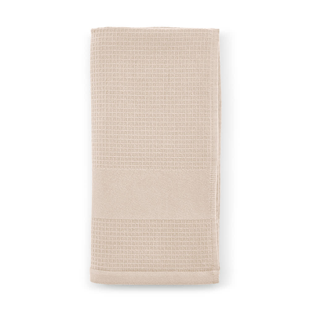 A cotton towel in a soft beige hue, featuring a textured design and subtle branding. Made in Portugal, 500 gsm.