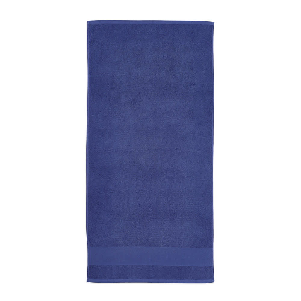 A deep blue cotton towel, 500 gsm, made in Portugal, featuring a simple design and a logo.