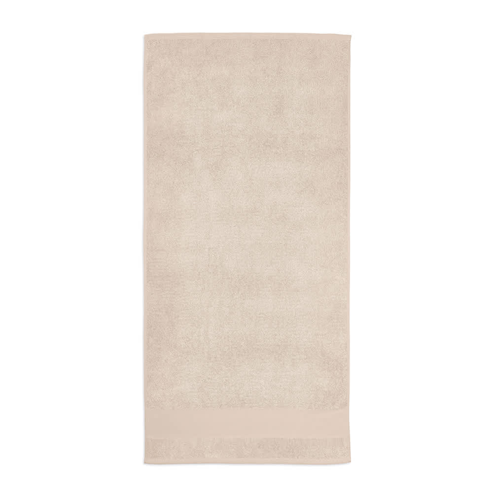 A beige cotton towel with a soft texture, featuring a branding logo at one end.