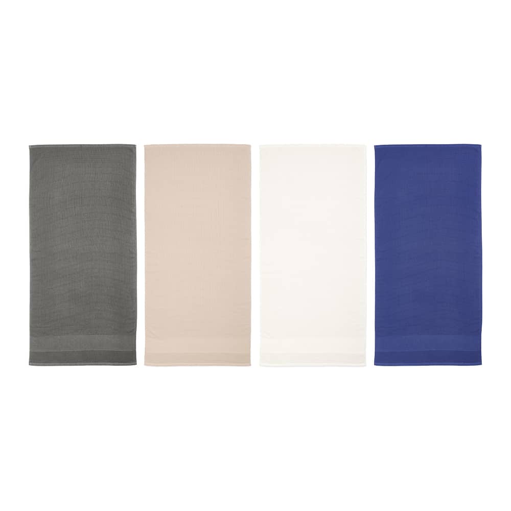 A set of four towels in grey, beige, white, and blue, displayed in a row. Each towel has a logo.