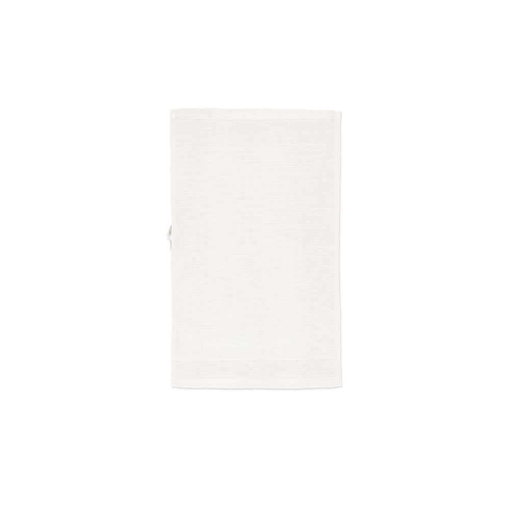 A cotton towel in a soft cream colour, featuring a textured design, with a small attached loop for hanging.