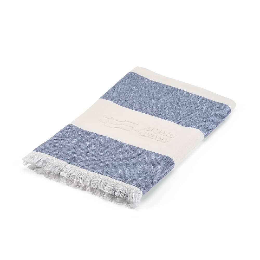 A cotton towel in blue and white stripes with a fringed edge and a logo. Made in Portugal, 350gsm.