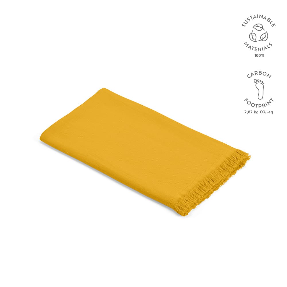 A yellow cotton towel with fringe edges, made in Portugal and featuring a logo.