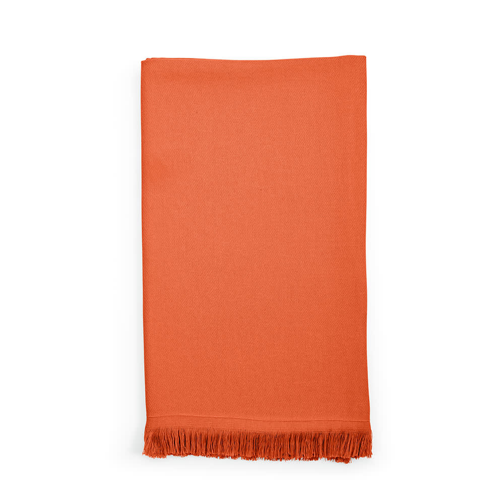 An orange cotton towel with fringing at the edges, made in Portugal. It has a logo or branding.