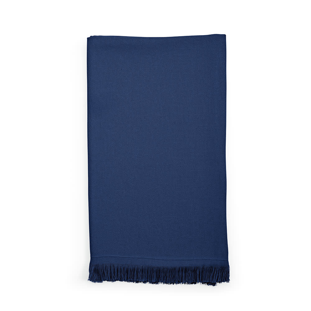A navy blue cotton towel with fringe detailing, made in Portugal, featuring a logo.