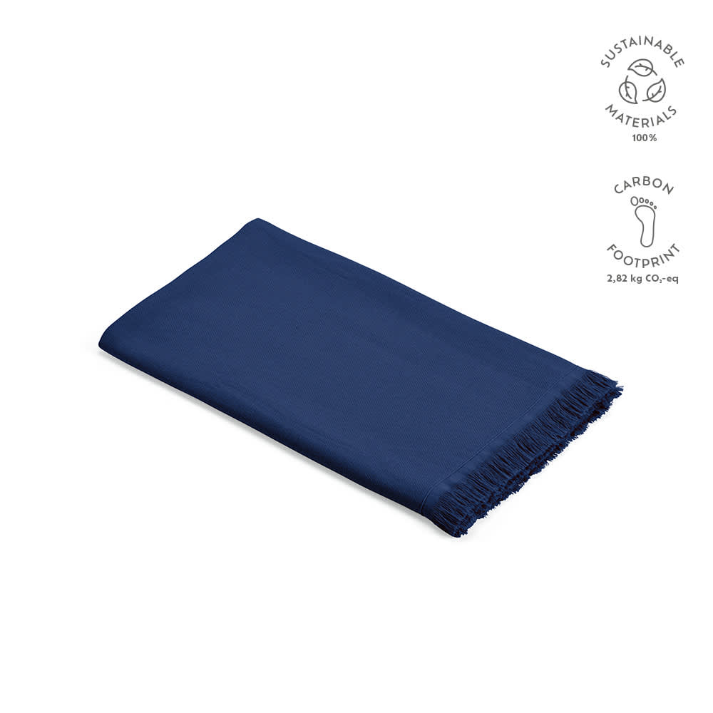 A navy cotton towel with fringing, made in Portugal from sustainable materials. Features a logo.