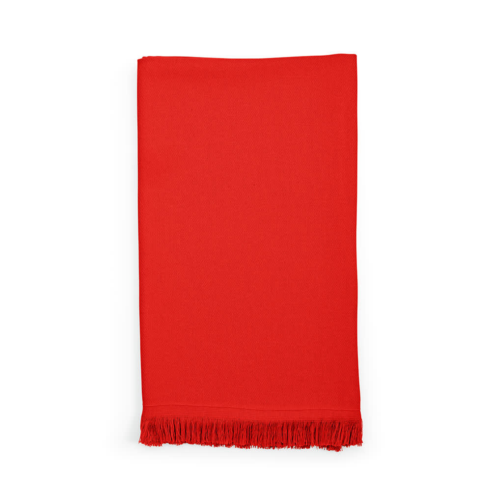 A red cotton towel with fringe detailing, made in Portugal. It features a logo or branding.