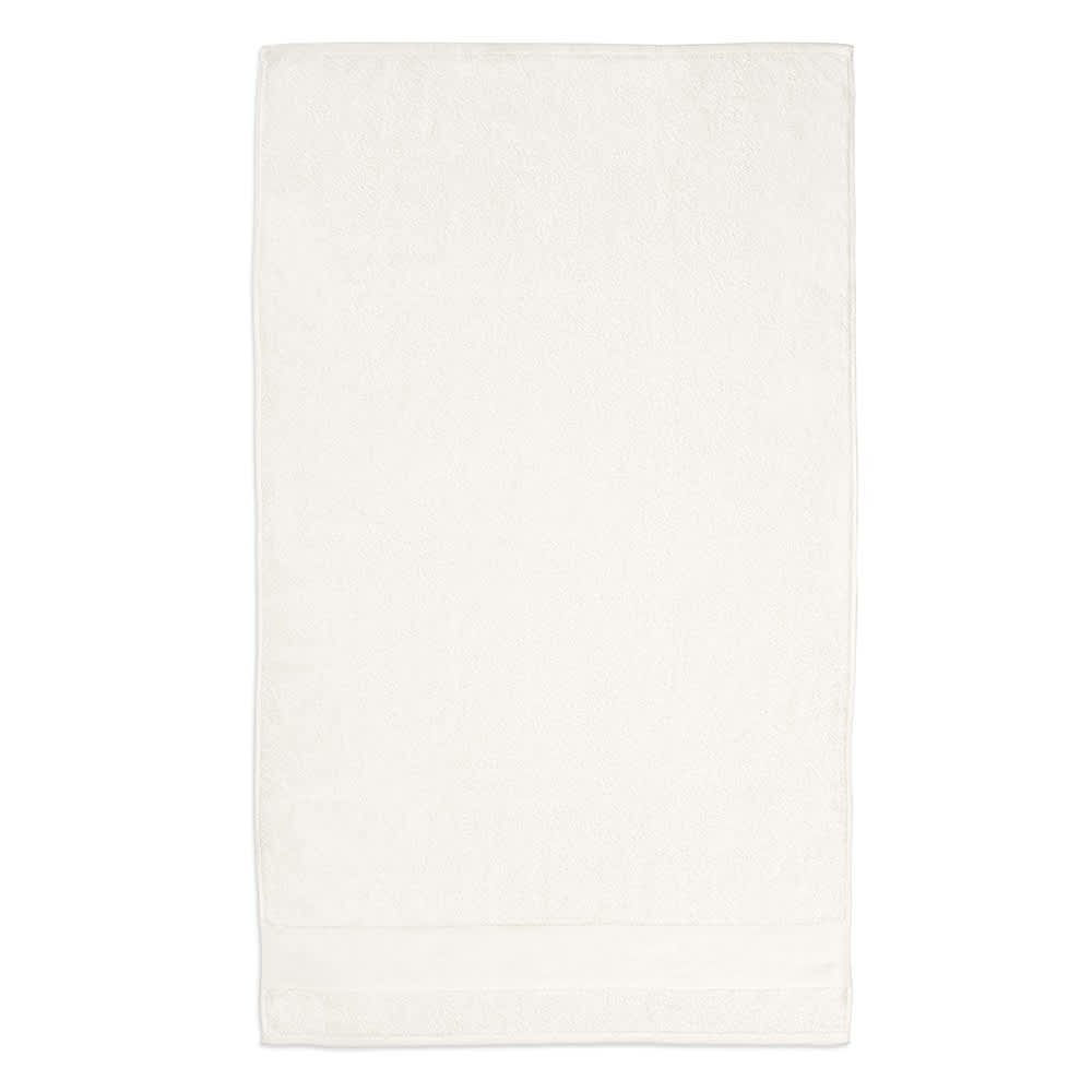 A white cotton towel displaying a textured border, featuring a logo on one corner. Made in Portugal.