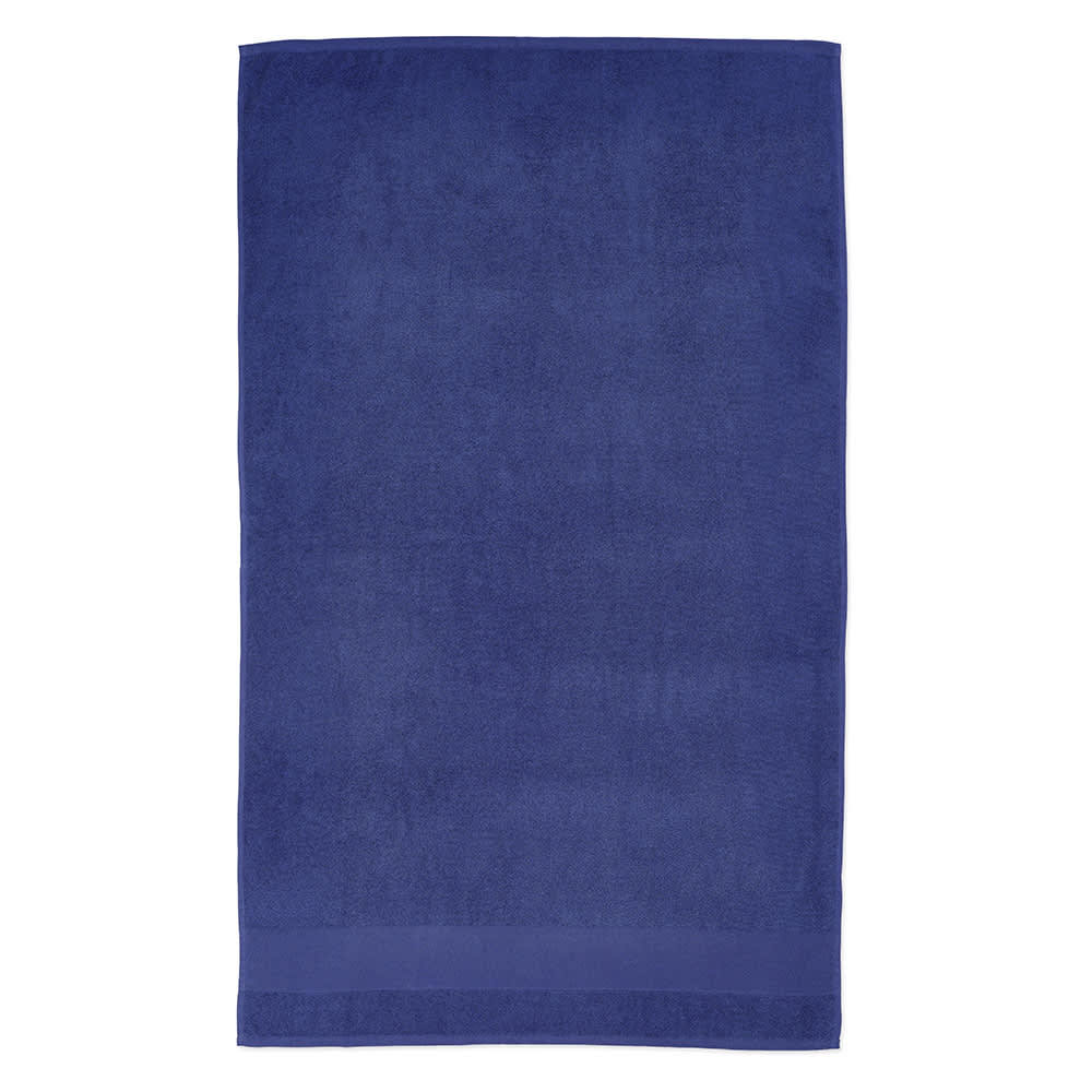 A large navy blue towel made from cotton, featuring a soft texture and a discreet logo.