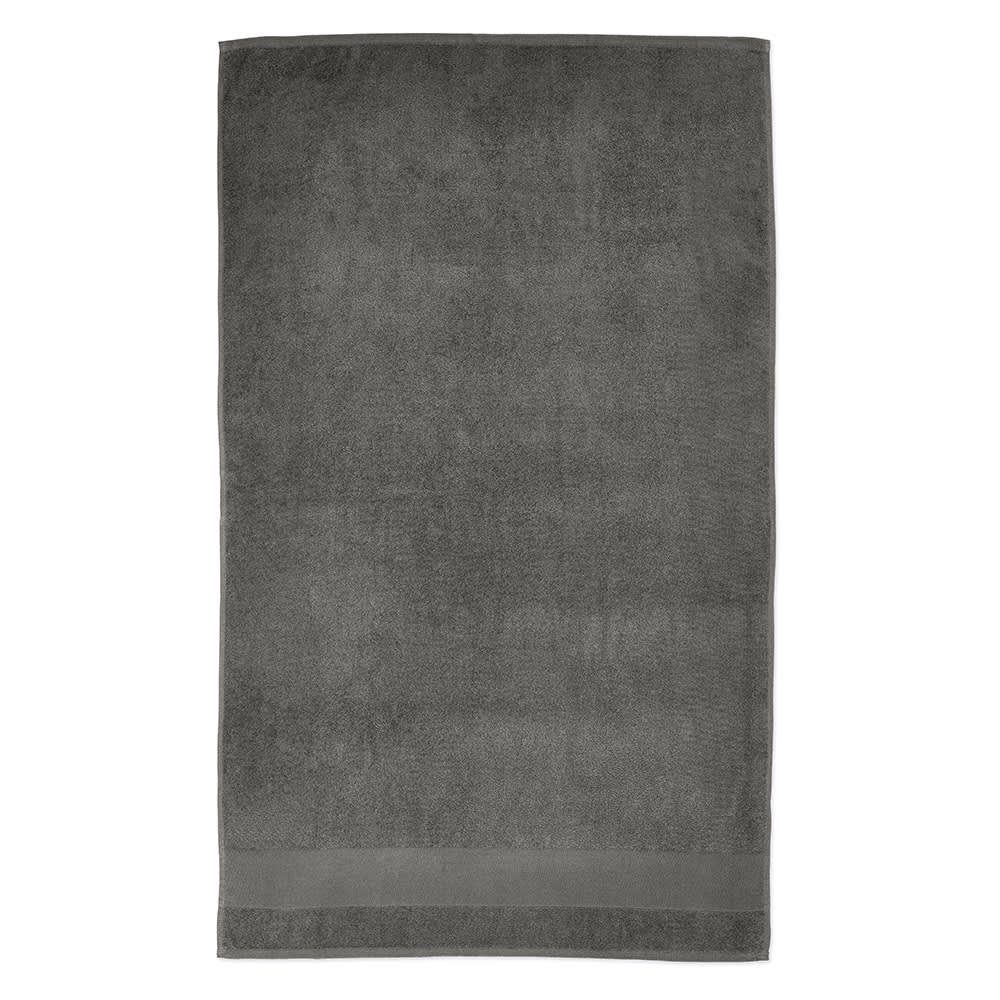 A grey cotton towel featuring a soft texture with a subtle border, made in Portugal. It includes a branding logo.