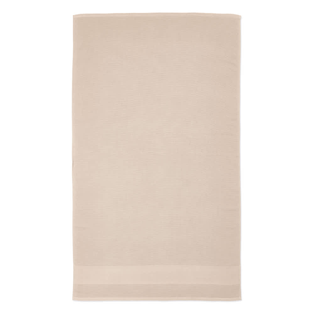 A beige towel made of recycled cotton, featuring a subtle textured pattern and a logo at the bottom.