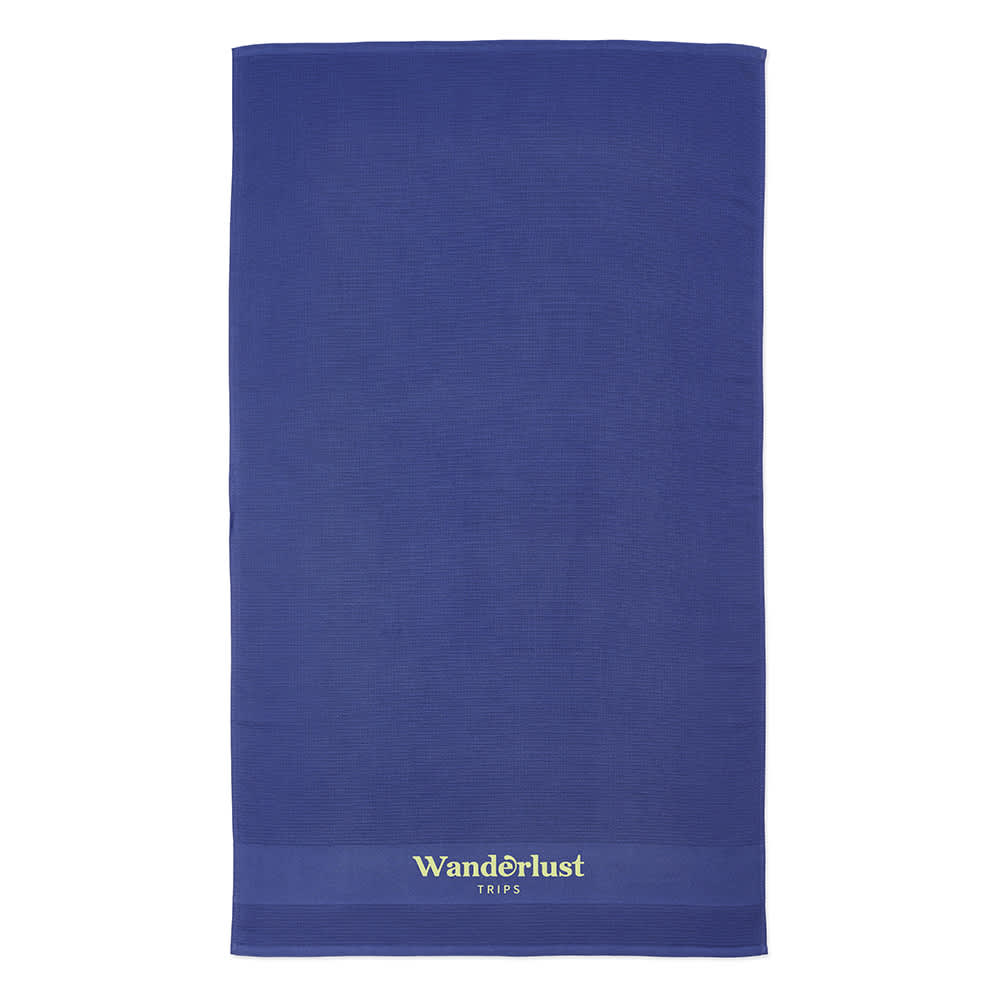 A blue recycled cotton towel with a logo at the base, featuring a textured design.