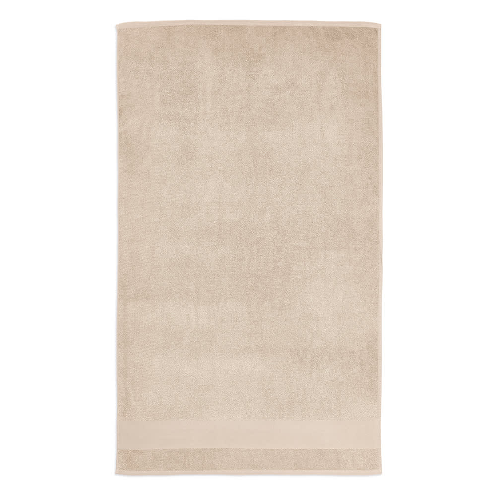 A beige towel made from recycled cotton, featuring a plush texture and a branded logo.