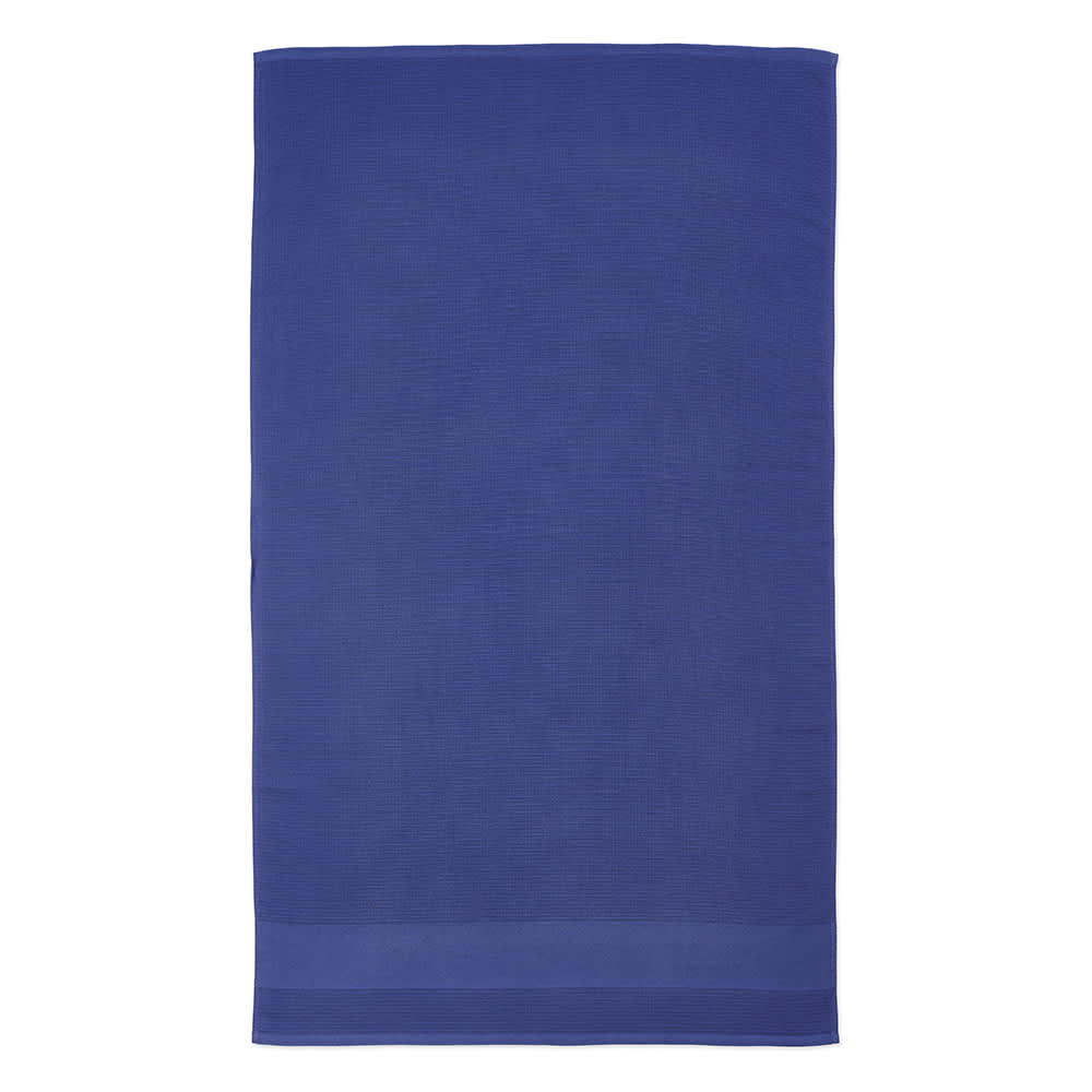 A large, navy blue towel made from recycled cotton with a textured design and a branded logo.