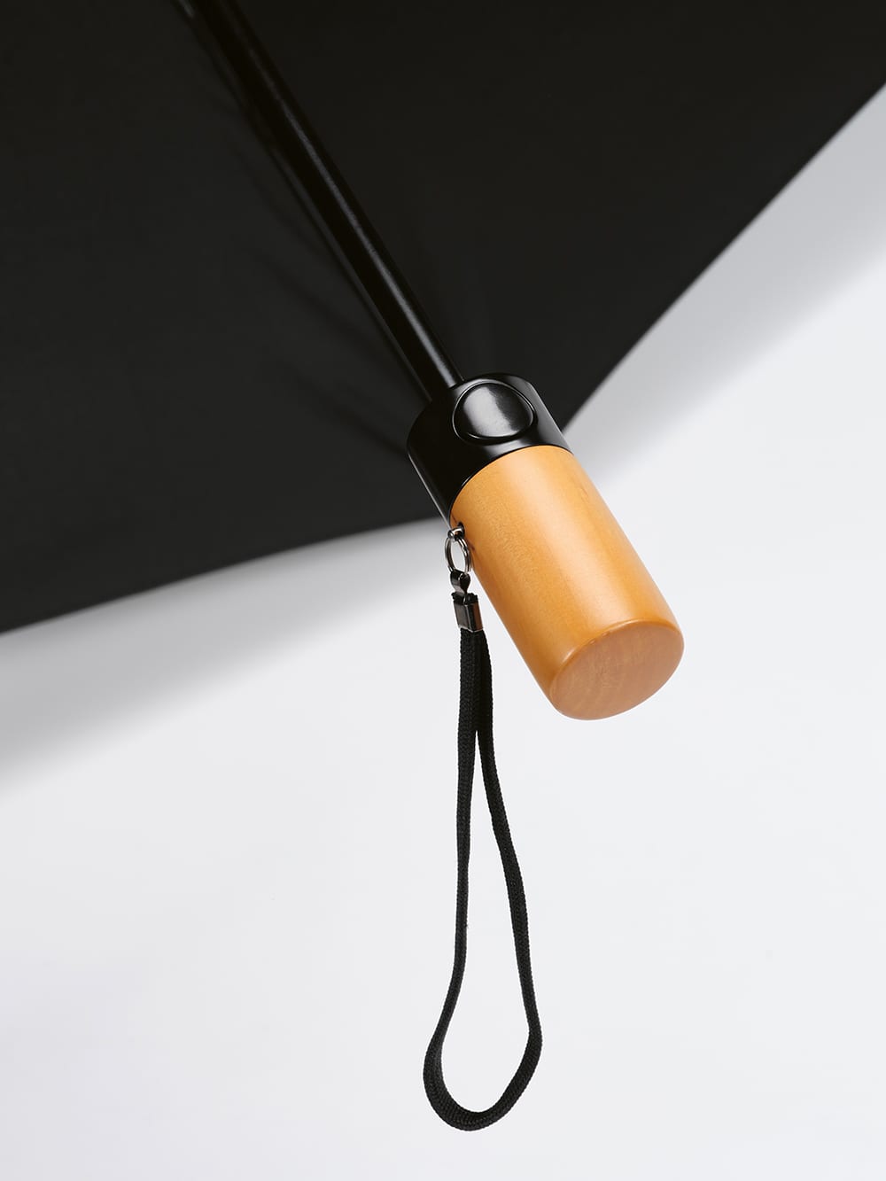 A black foldable umbrella with an automatic opening/closing feature, featuring a wooden handle and a wrist strap.