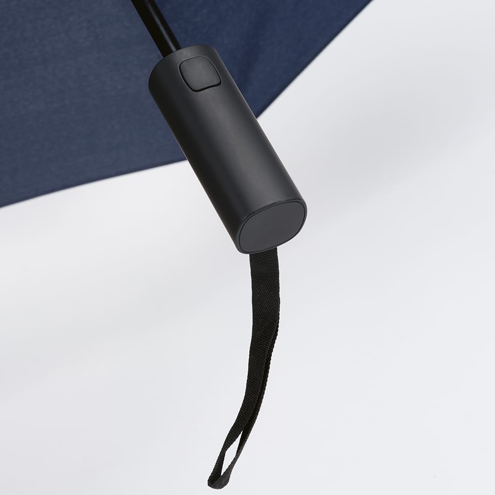 A black handle of a navy foldable and reversible umbrella, featuring a strap for easy carrying.