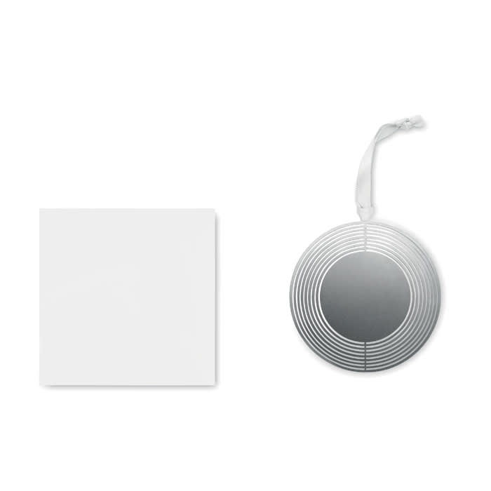 A silver circular mirror with a striped pattern beside a blank white card. The mirror has a hanging ribbon.
