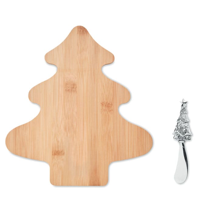 A bamboo cheese board shaped like a Christmas tree, accompanied by a silver spreader with a tree design.
