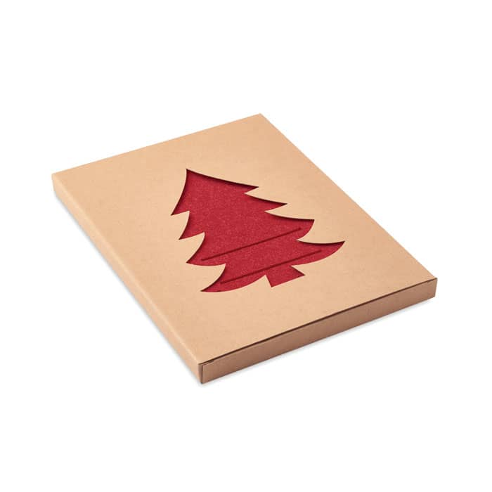 A gift box featuring a cut-out glittery red Christmas tree design on a kraft paper background.