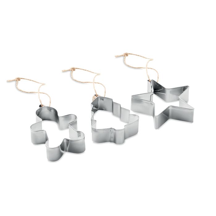 Three metal cookie cutters in the shapes of a gingerbread man, tree, and star, each with a string attached.