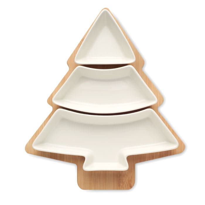 A serving platter shaped like a Christmas tree, featuring three white ceramic dishes on a wooden base.