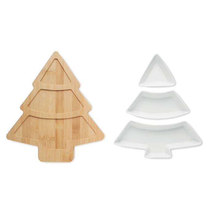 A wooden tree-shaped serving platter with three white triangular dishes beside it. The platter features two cut-out layers.