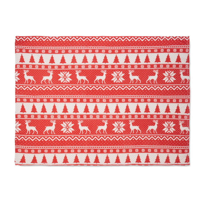 A festive red and white patterned table runner featuring reindeer, trees, and snowflakes in a Christmas design.