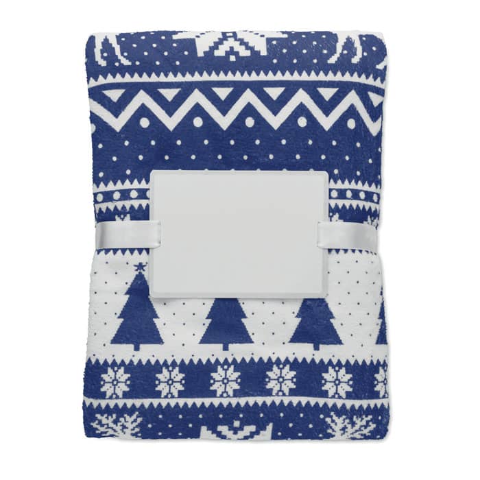 A blanket featuring a blue and white geometric design with trees and snowflakes, secured with a white strap.