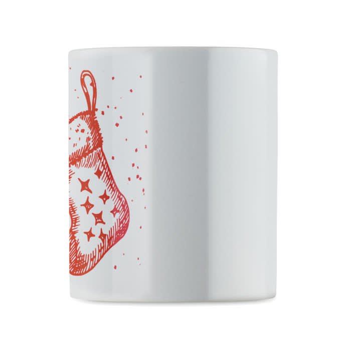 A white mug featuring a red illustration of a Christmas stocking with decorative stars.