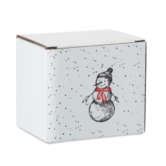 A white box with a snowman illustration, featuring black speckles and a red scarf. The box has a simple, festive design.
