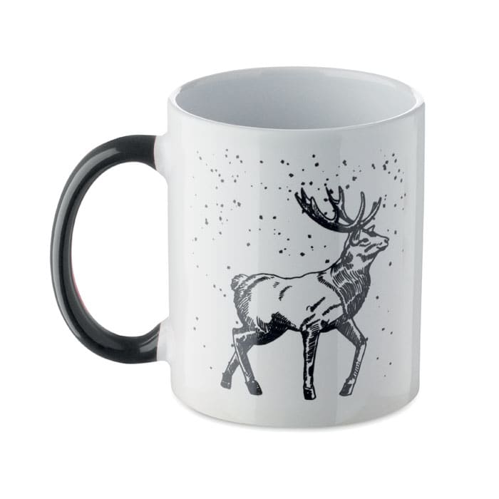 A drink mug in white with a black handle, featuring a sketch of a deer and snowflakes design.