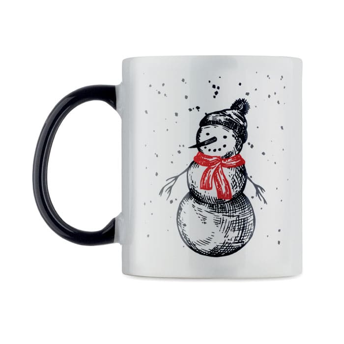 A white mug with a black handle, featuring a snowman illustration in red and black.