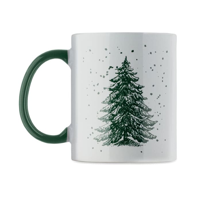 A mug featuring a green handle and a white body decorated with a green Christmas tree design.