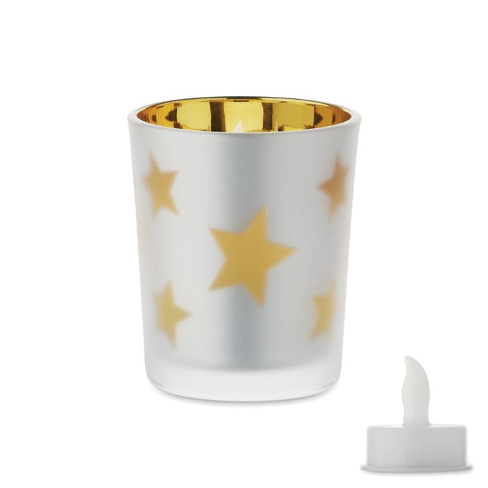 A drink bottle with a frosted white exterior featuring gold stars and a golden interior, accompanied by a white candle.