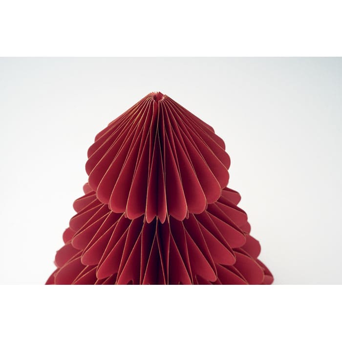 A decorative red paper sculpture resembling a tree, featuring layered, scalloped edges. It has a plain white background.