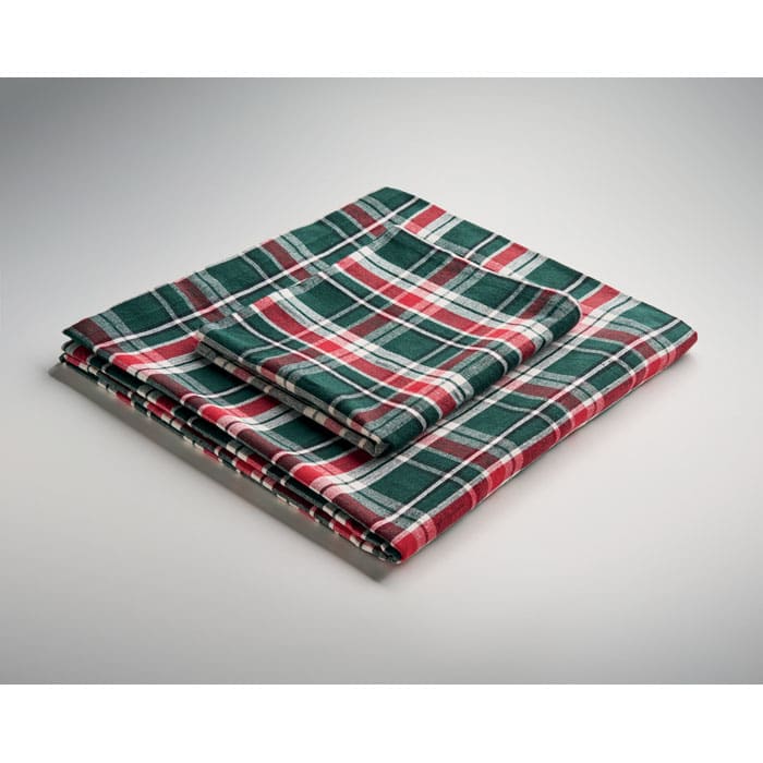 A folded tablecloth featuring a red, green, and white plaid pattern, arranged neatly on a light background.