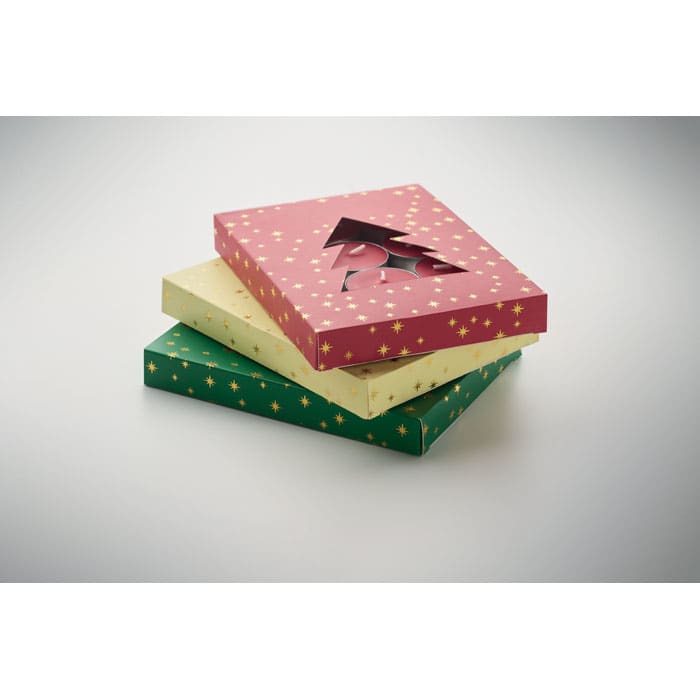 Three gift boxes stacked together: one pink with gold stars, one yellow, and one green with gold stars.