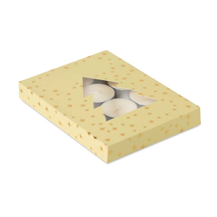 A gift box in yellow with star patterns, containing several white tea light candles visible through a clear window.