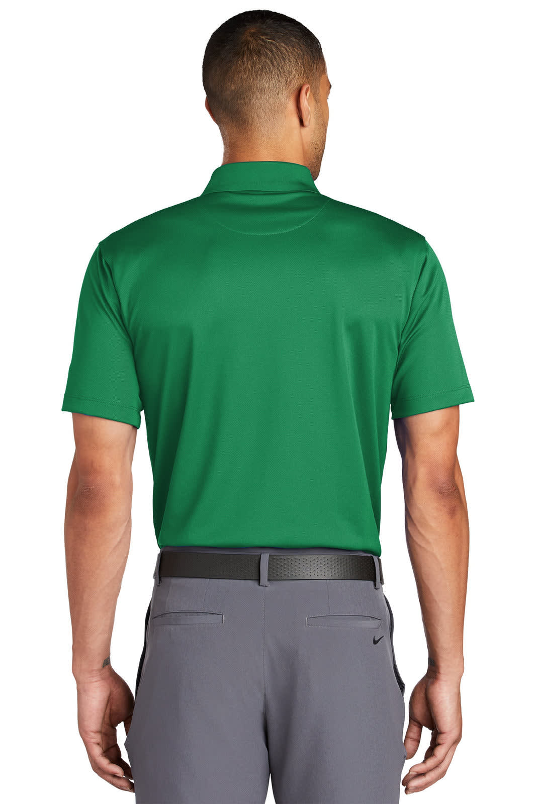 A green Nike Tech Basic Dri-FIT polo shirt, viewed from the back, featuring a clean design and a branding logo.