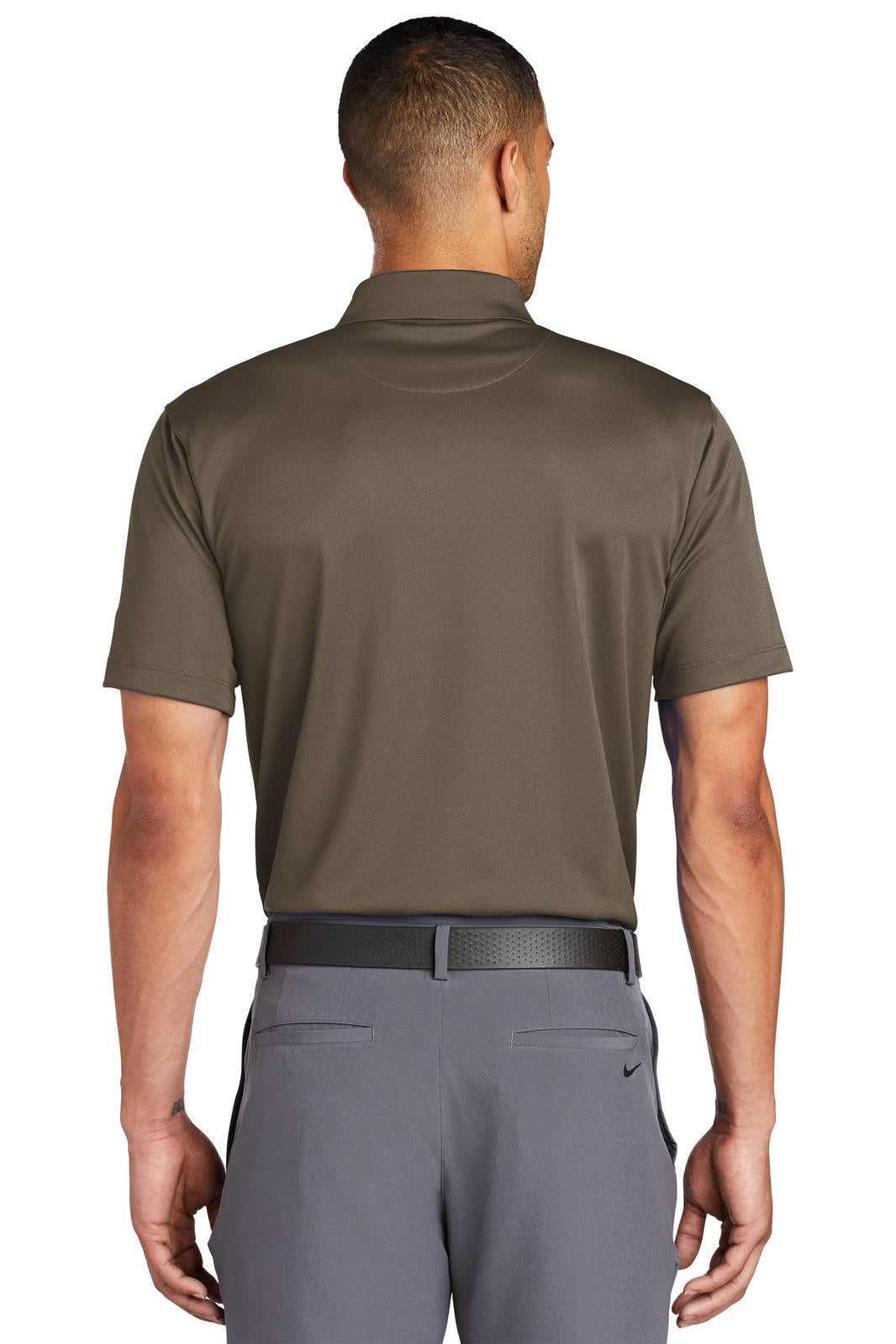 A man wearing a dark brown Nike polo shirt from the back, featuring a logo. The shirt has a sleek, fitted design.