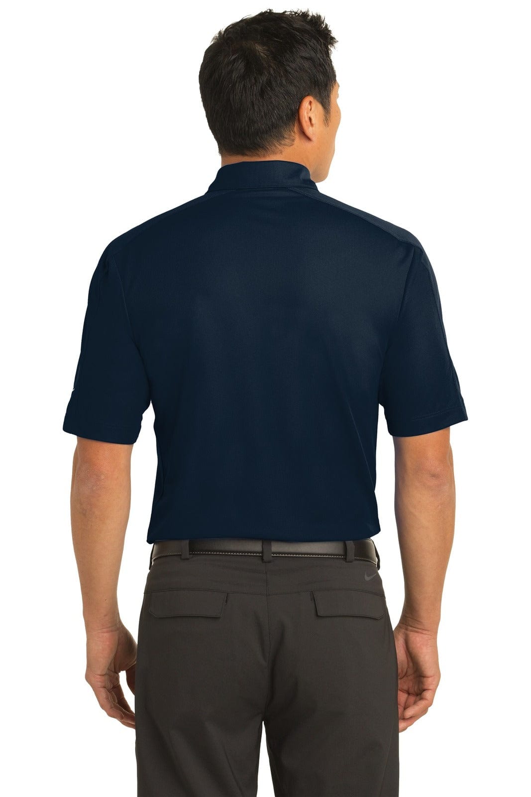A man wearing a navy blue Nike Tech Sport Dri-FIT polo shirt, viewed from the back. The shirt features a logo.