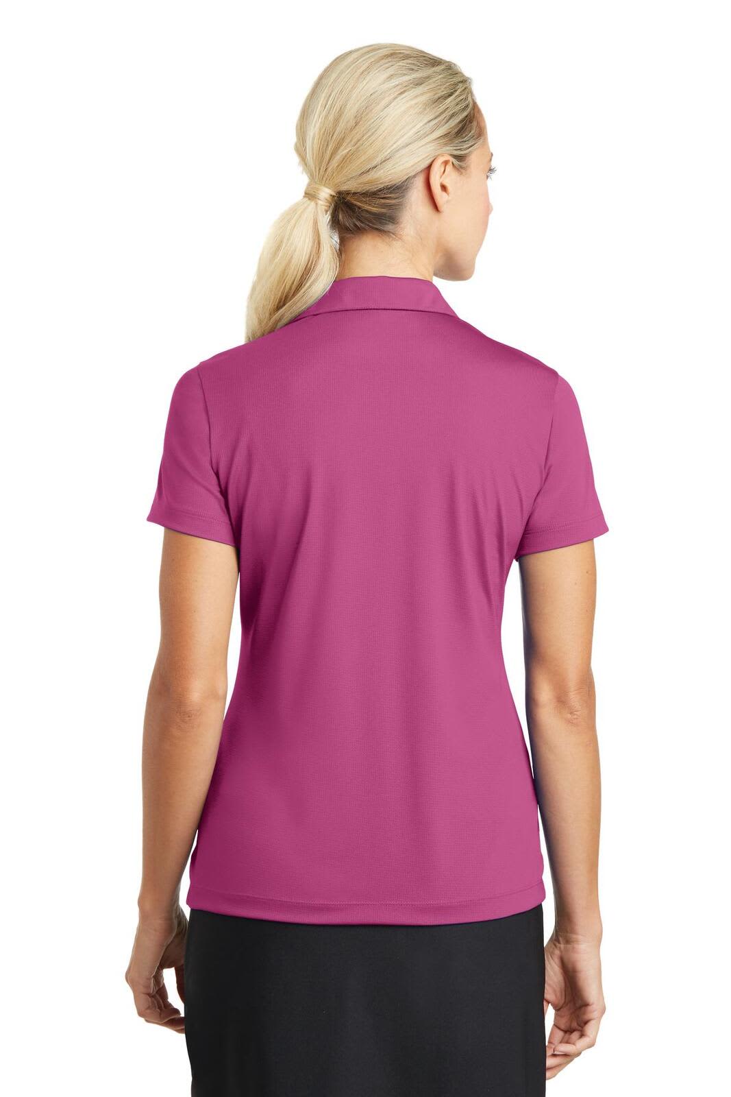 A pink Nike ladies' Dri-FIT vertical mesh polo shirt, featuring a collar and short sleeves, with a branding logo.