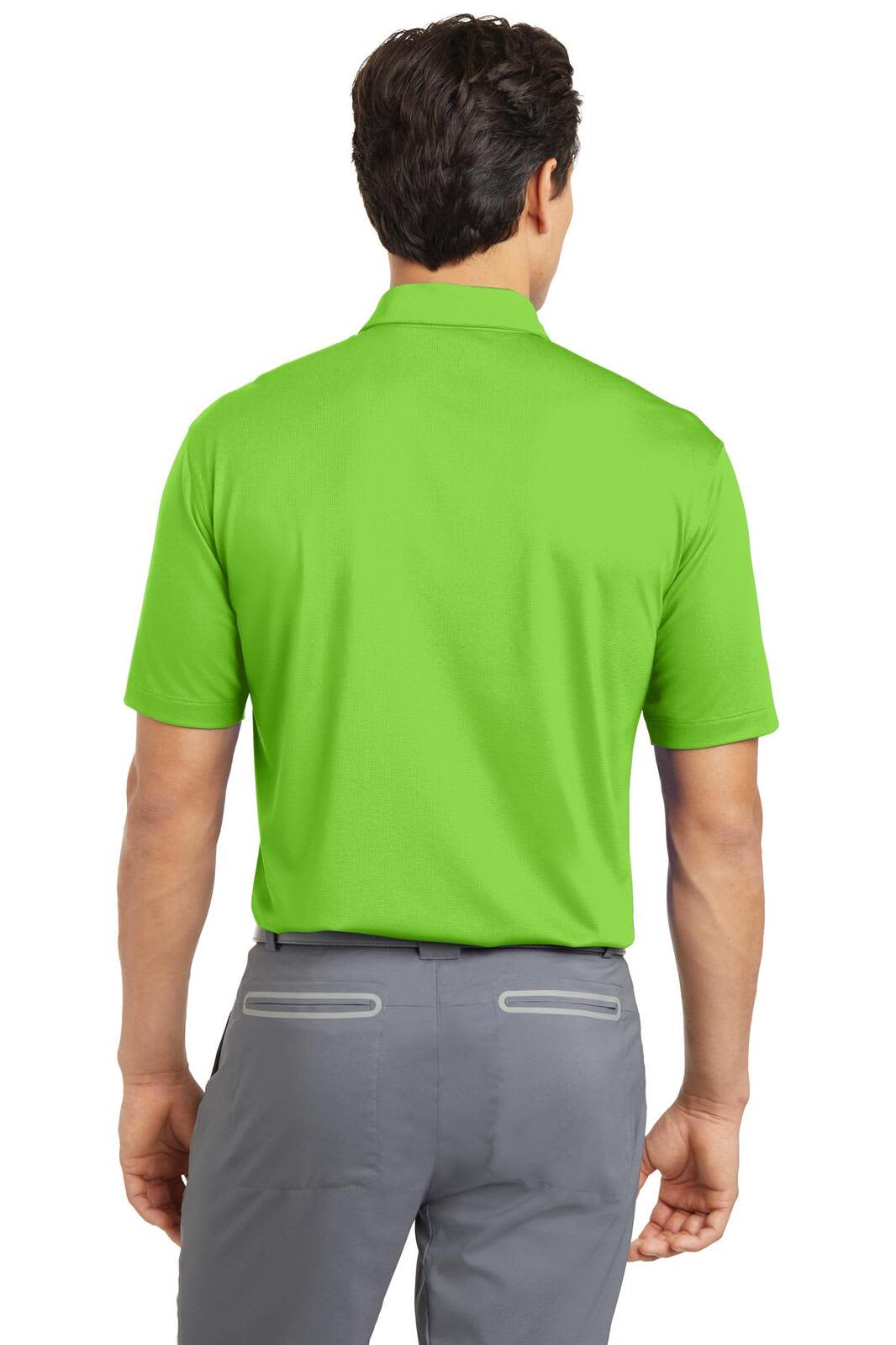 A man wearing a bright green Nike Dri-FIT polo shirt, viewed from the back, with grey trousers. The shirt features a logo.