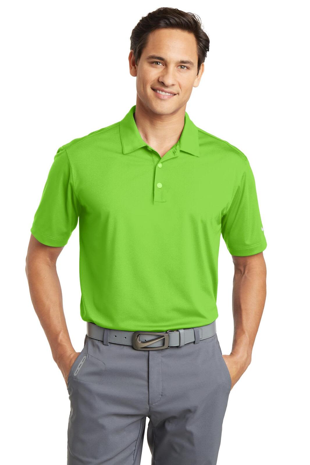 A bright green Nike Dri-FIT Vertical Mesh Polo is displayed on a model, paired with grey trousers. The polo has a logo.
