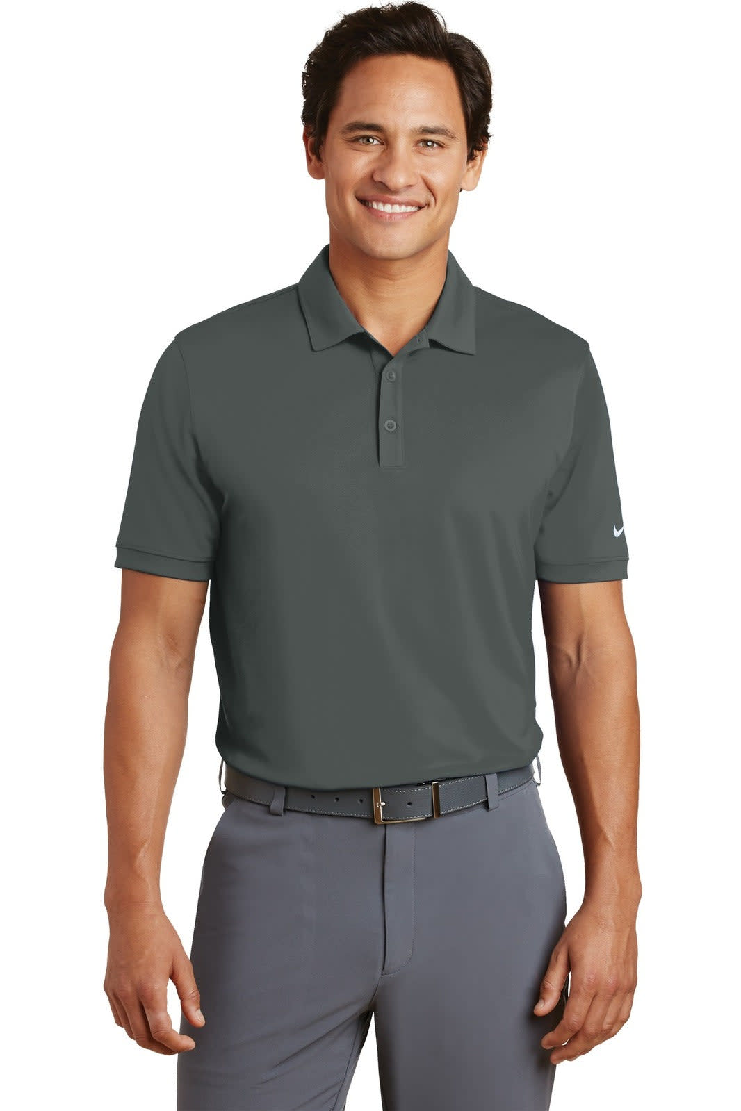 A man stands wearing a dark grey Nike Dri-FIT Players Modern Fit Polo, featuring a logo on one sleeve.