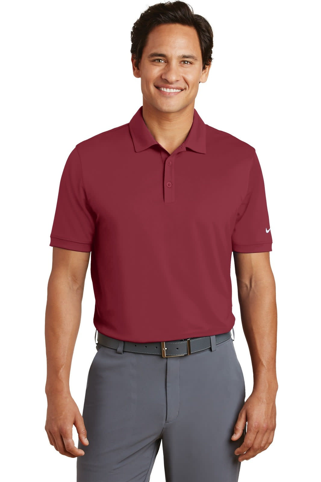 A man is wearing a maroon Nike Dri-FIT modern fit polo shirt, paired with grey trousers. The shirt features a logo.