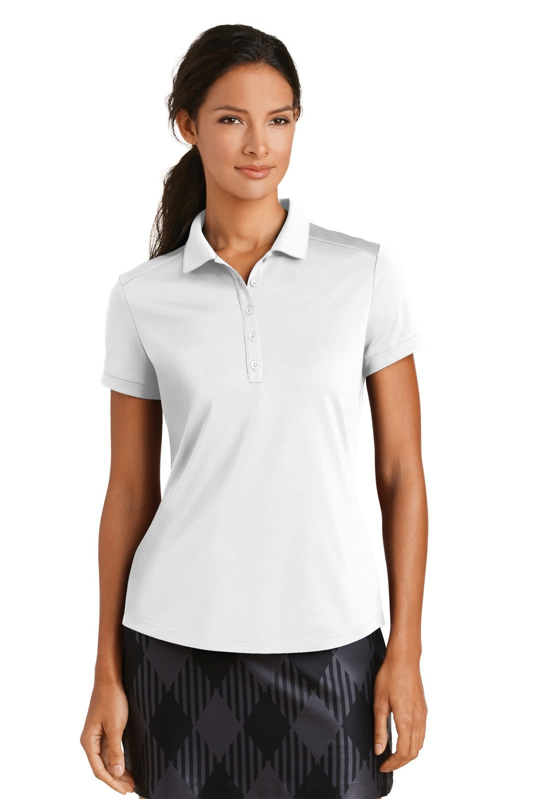 A white ladies' polo shirt with a modern fit and collar, featuring a logo. Styled with a patterned black skirt.