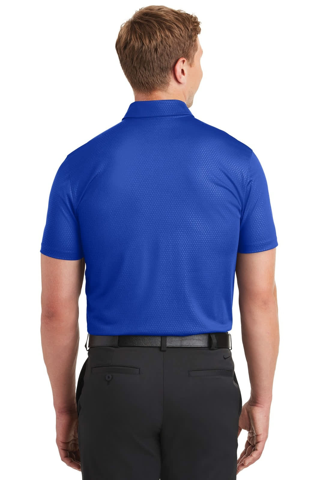 A man wearing a blue Nike Dri-FIT Embossed Tri-Blade Polo from the back, paired with black trousers.