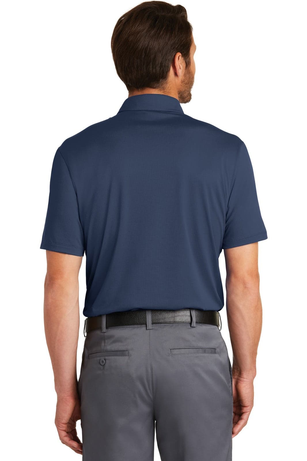 A navy blue Nike Dri-FIT Legacy Polo shirt viewed from the back, worn with grey trousers. The shirt features a logo.
